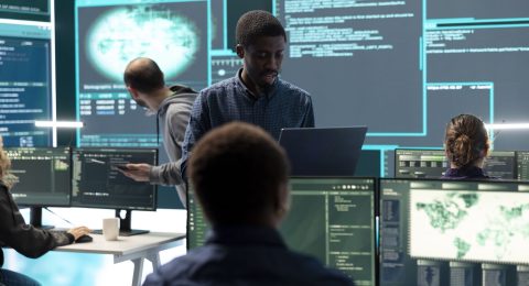 Governmental hackers working on computer network in high tech office